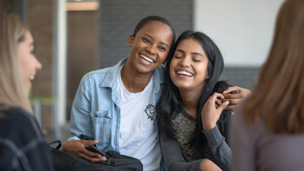 two friends hugging showing community